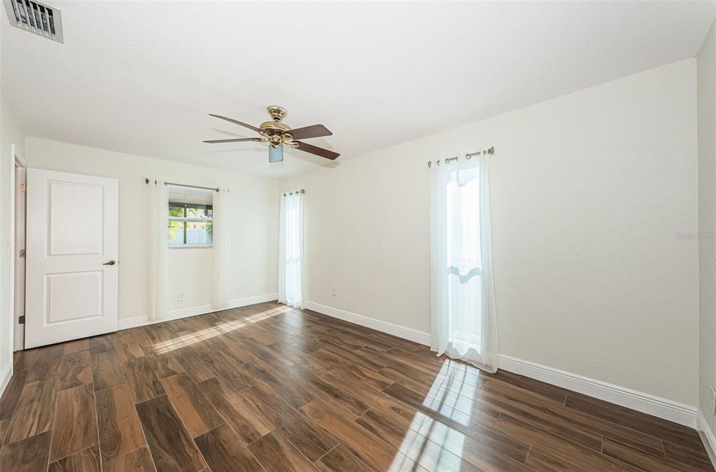 4723 114th Street North Madeira Beach, FL 33708 - Photo 23 of 41 wooden floor in an empty room with a window