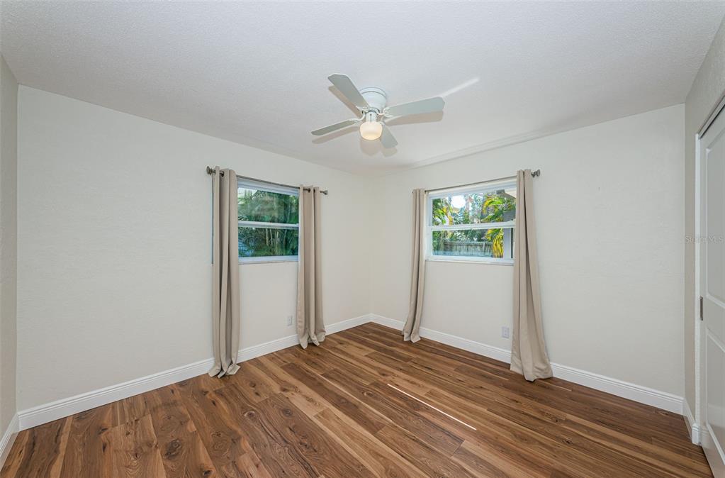 4723 114th Street North Madeira Beach, FL 33708 - Photo 33 of 41 a view of a room with wooden floor and a ceiling fan