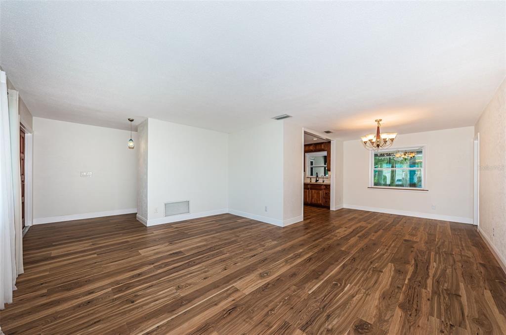 4723 114th Street North Madeira Beach, FL 33708 - Photo 9 of 41 wooden floor in an empty room with a window