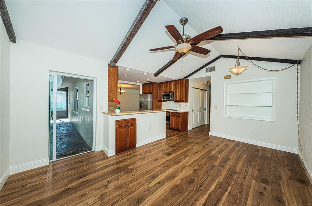 4723 114th Street North Madeira Beach, FL 33708 - Photo 10 of 41 a view of a kitchen with wooden floor and a ceiling fan