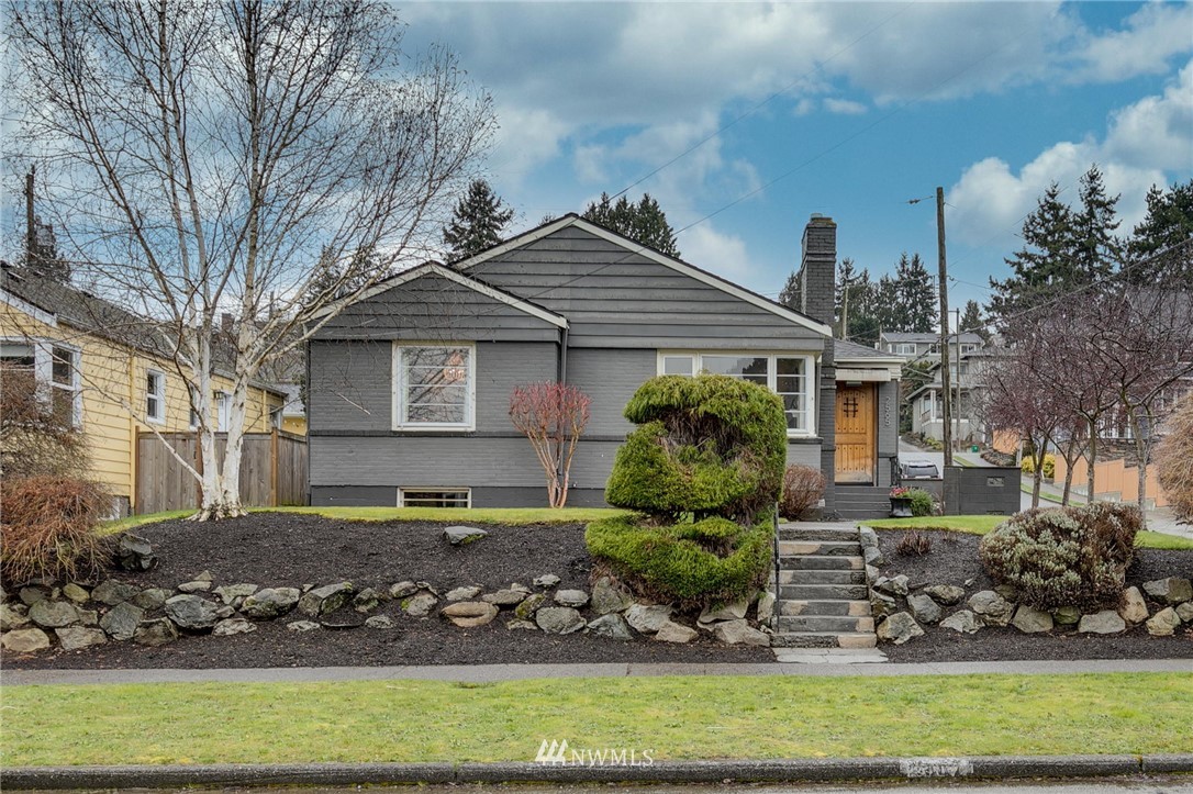 2565 35th Avenue West Seattle, WA 98199 - Photo 1 of 36 a front view of a house with a garden