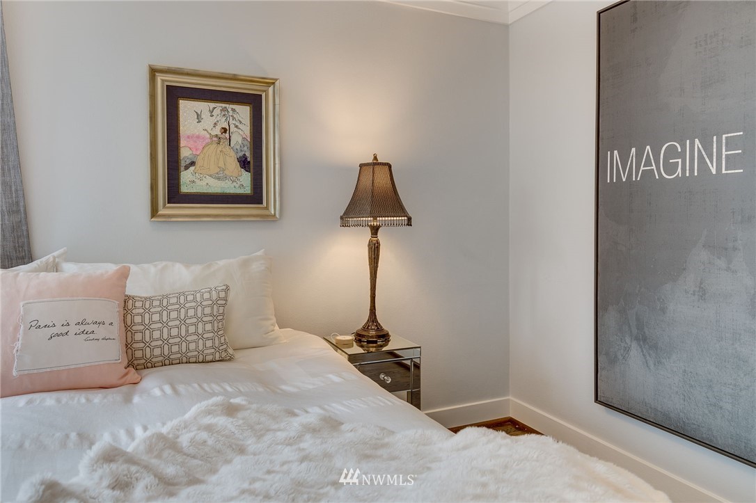 2565 35th Avenue West Seattle, WA 98199 - Photo 14 of 36 a bedroom with a bed and a table