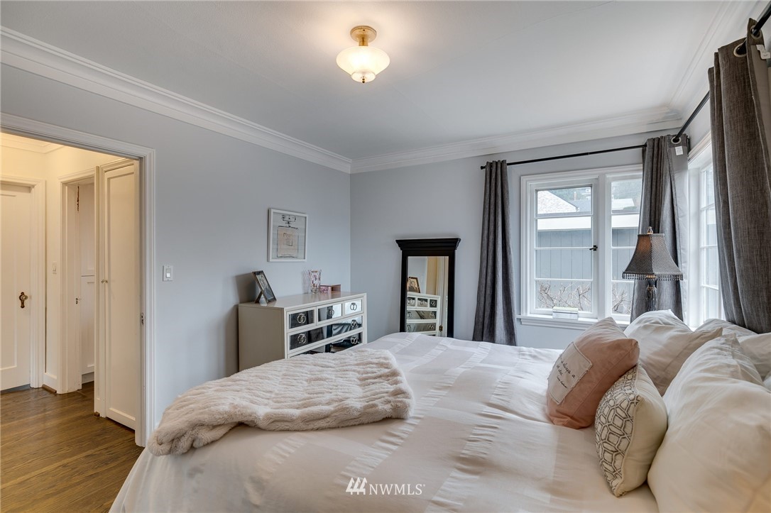 2565 35th Avenue West Seattle, WA 98199 - Photo 16 of 36 a bedroom with a bed and a large window