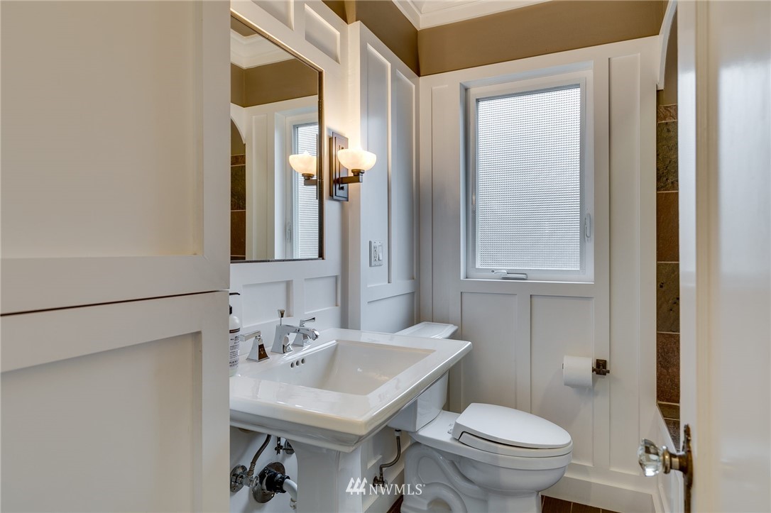 2565 35th Avenue West Seattle, WA 98199 - Photo 17 of 36 a bathroom with a sink toilet and mirror