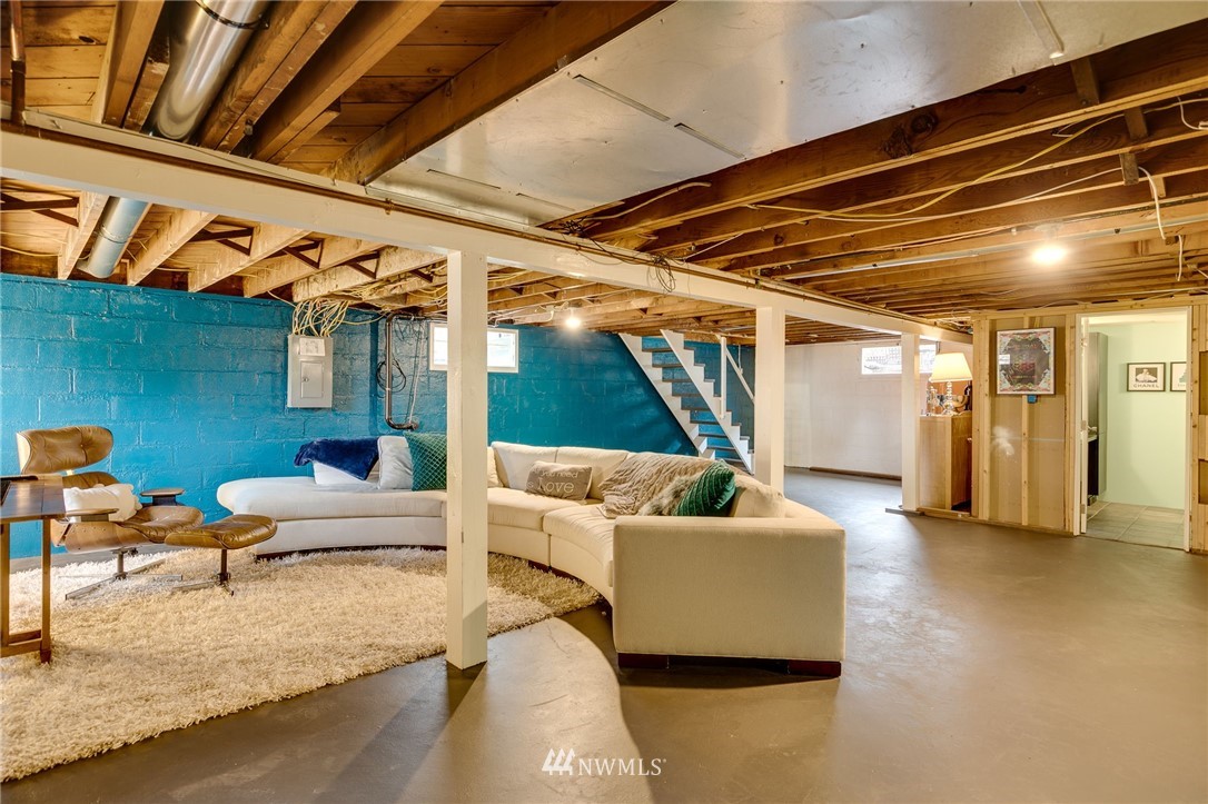 2565 35th Avenue West Seattle, WA 98199 - Photo 21 of 36 a living room with furniture and a ceiling fan