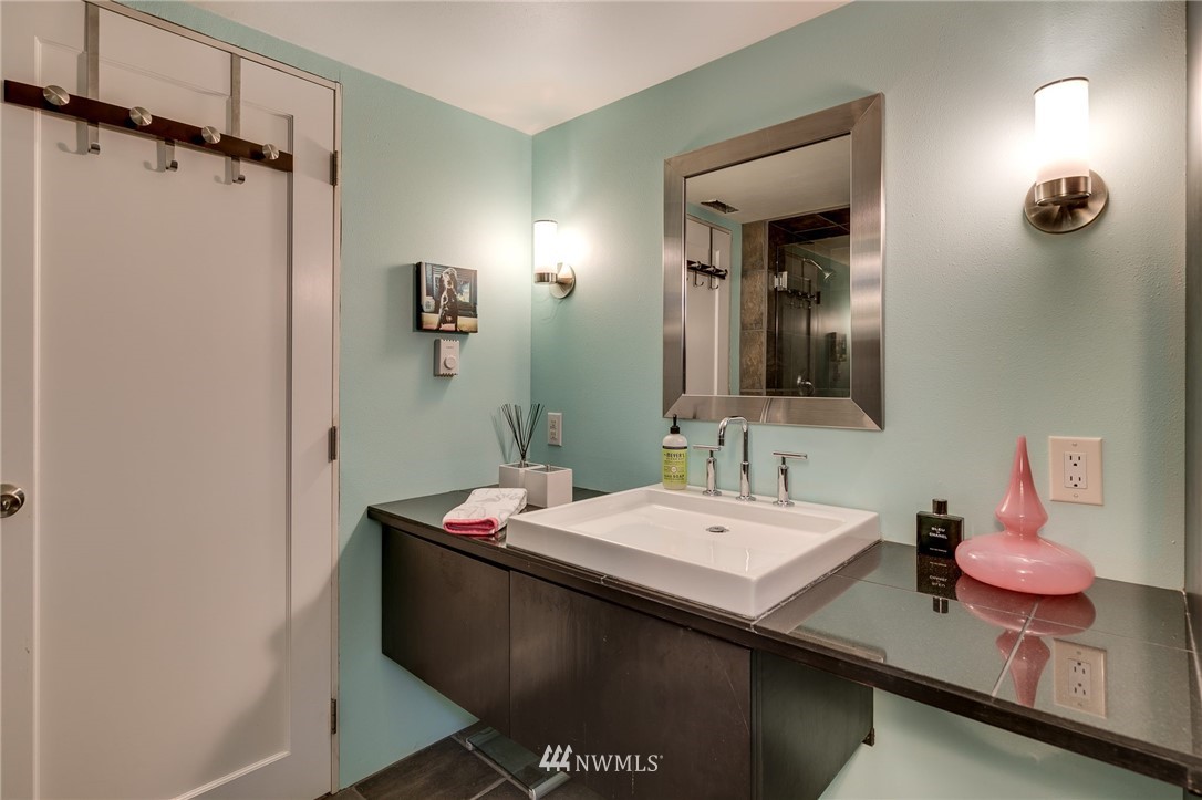 2565 35th Avenue West Seattle, WA 98199 - Photo 23 of 36 a bathroom with a sink vanity and mirror