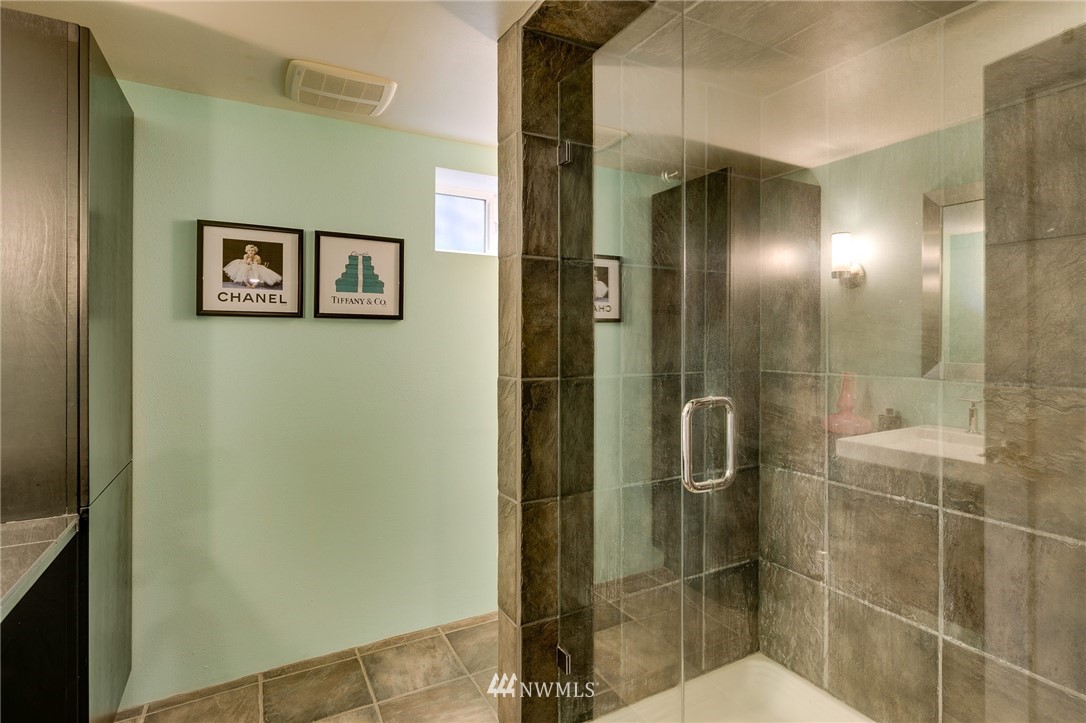 2565 35th Avenue West Seattle, WA 98199 - Photo 24 of 36 a bathroom with a shower and a sink