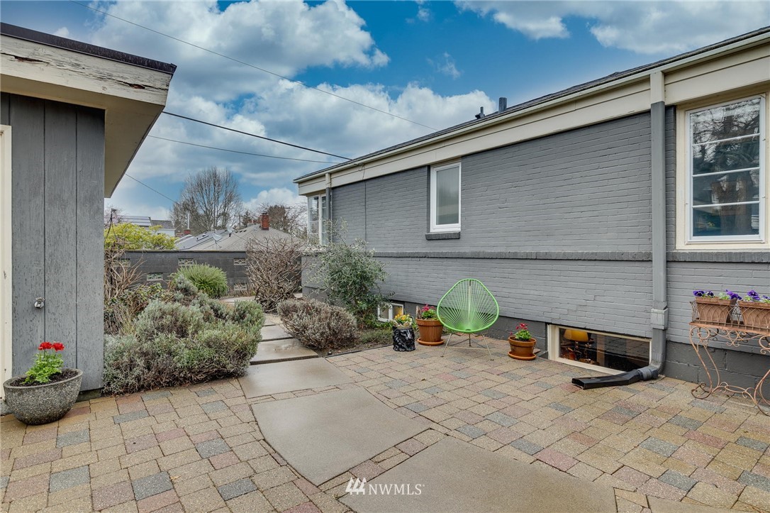 2565 35th Avenue West Seattle, WA 98199 - Photo 28 of 36 a view of backyard with outdoor seating and plants