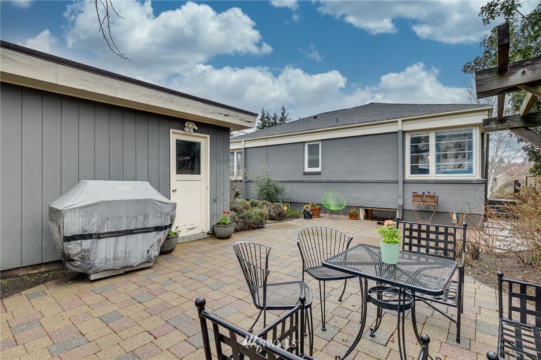 2565 35th Avenue West Seattle, WA 98199 - Photo 29 of 36 a patio with table and chairs and potted plants