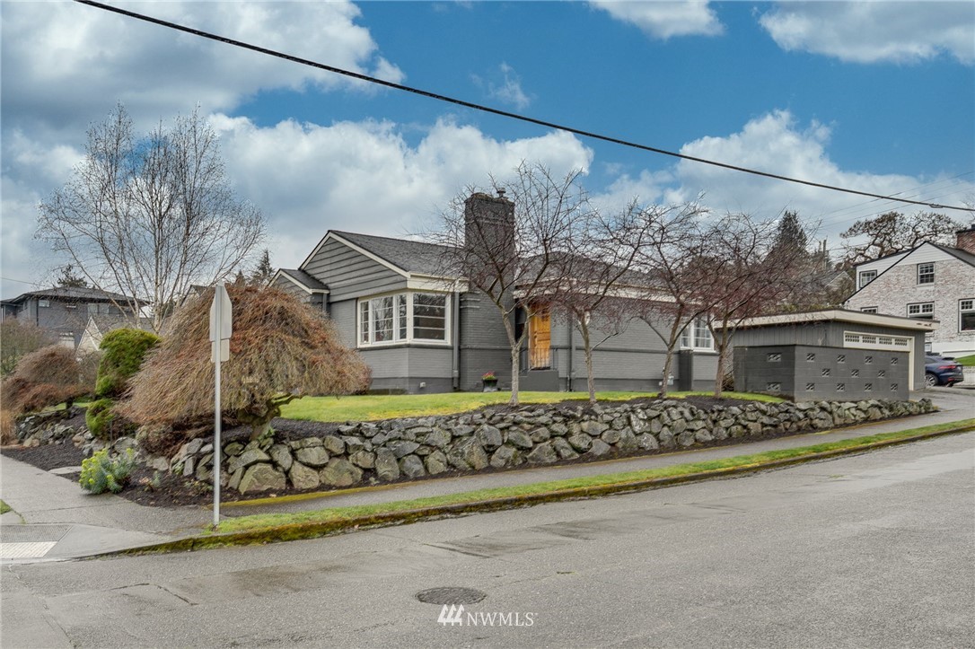 2565 35th Avenue West Seattle, WA 98199 - Photo 30 of 36 a front view of a house with a garden