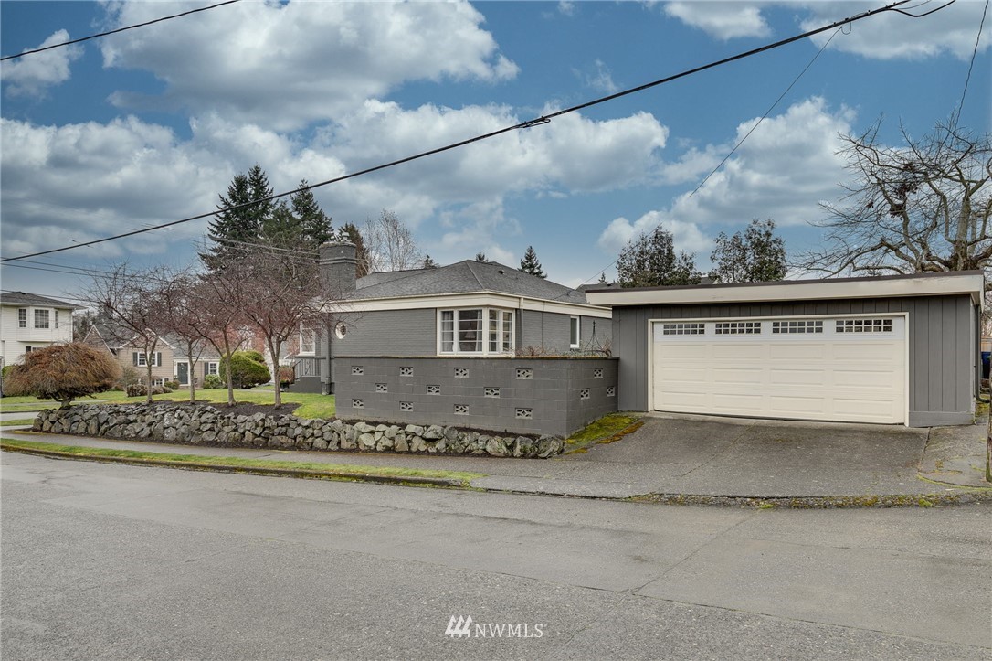 2565 35th Avenue West Seattle, WA 98199 - Photo 31 of 36 a front view of a house with a garden