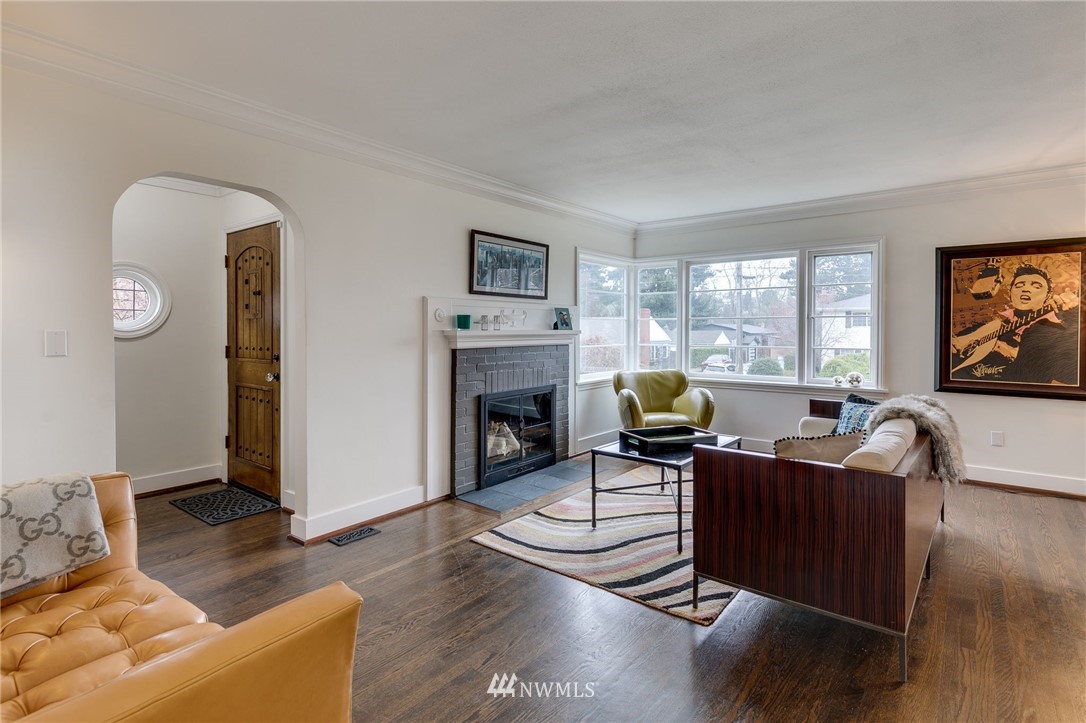 2565 35th Avenue West Seattle, WA 98199 - Photo 4 of 36 a living room with furniture a fireplace and a flat screen tv
