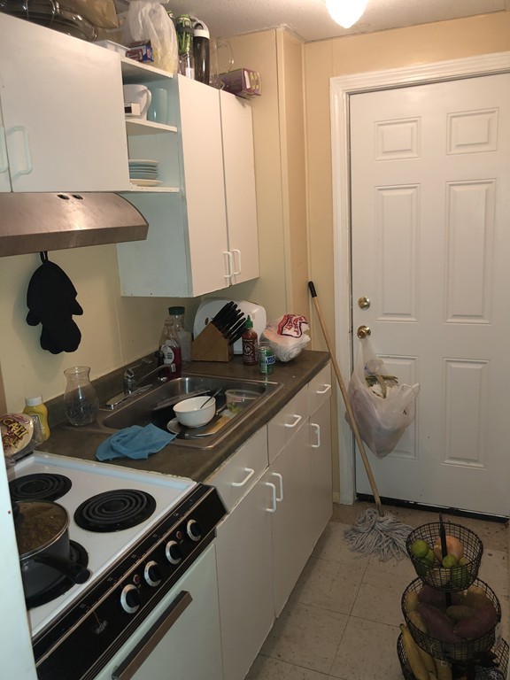 16 Prospect Court Lawrence, MA 01841 - Photo 2 of 14 a kitchen with a stove and a sink
