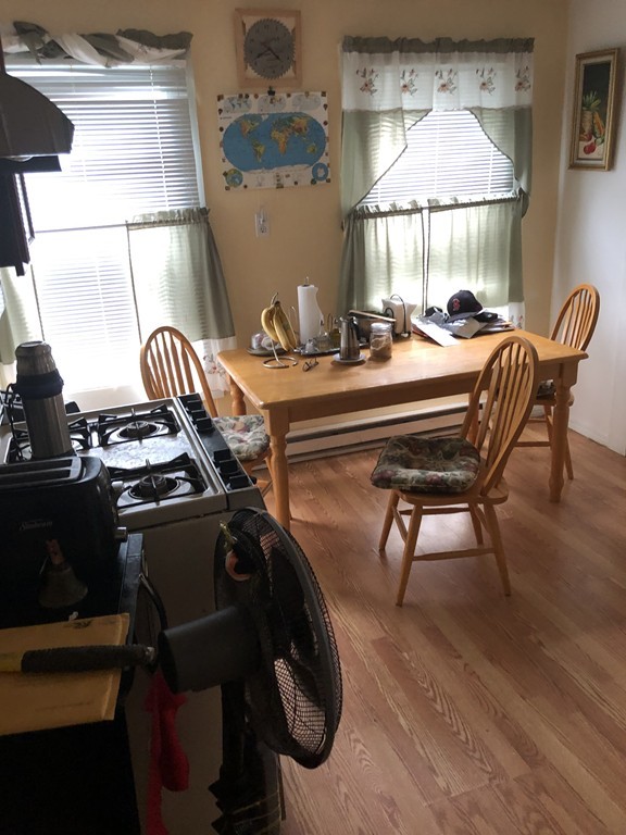 16 Prospect Court Lawrence, MA 01841 - Photo 3 of 14 a room with table chairs and wooden floor