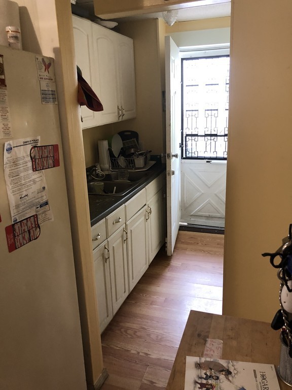 16 Prospect Court Lawrence, MA 01841 - Photo 9 of 14 a kitchen with granite countertop a refrigerator and a sink