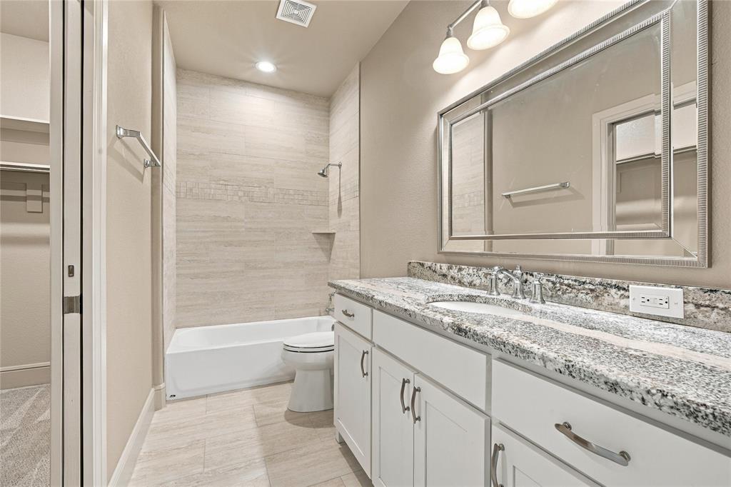1180 Wiggins Road Maypearl, TX 76064 - Photo 29 of 40 A well-appointed secondary bath with granite counters and clean white cabinetry.