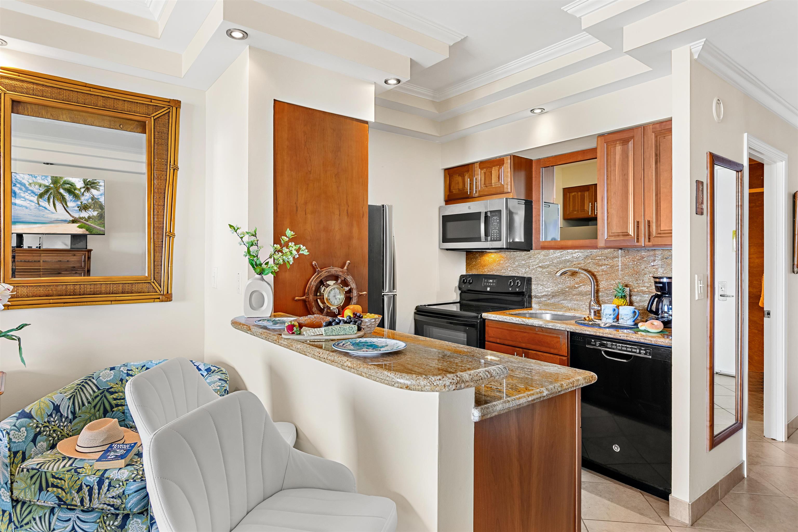 475 Front Street, Unit 635 Lahaina, HI 96761 - Photo 13 of 23 a kitchen with stainless steel appliances kitchen island granite countertop a sink and cabinets