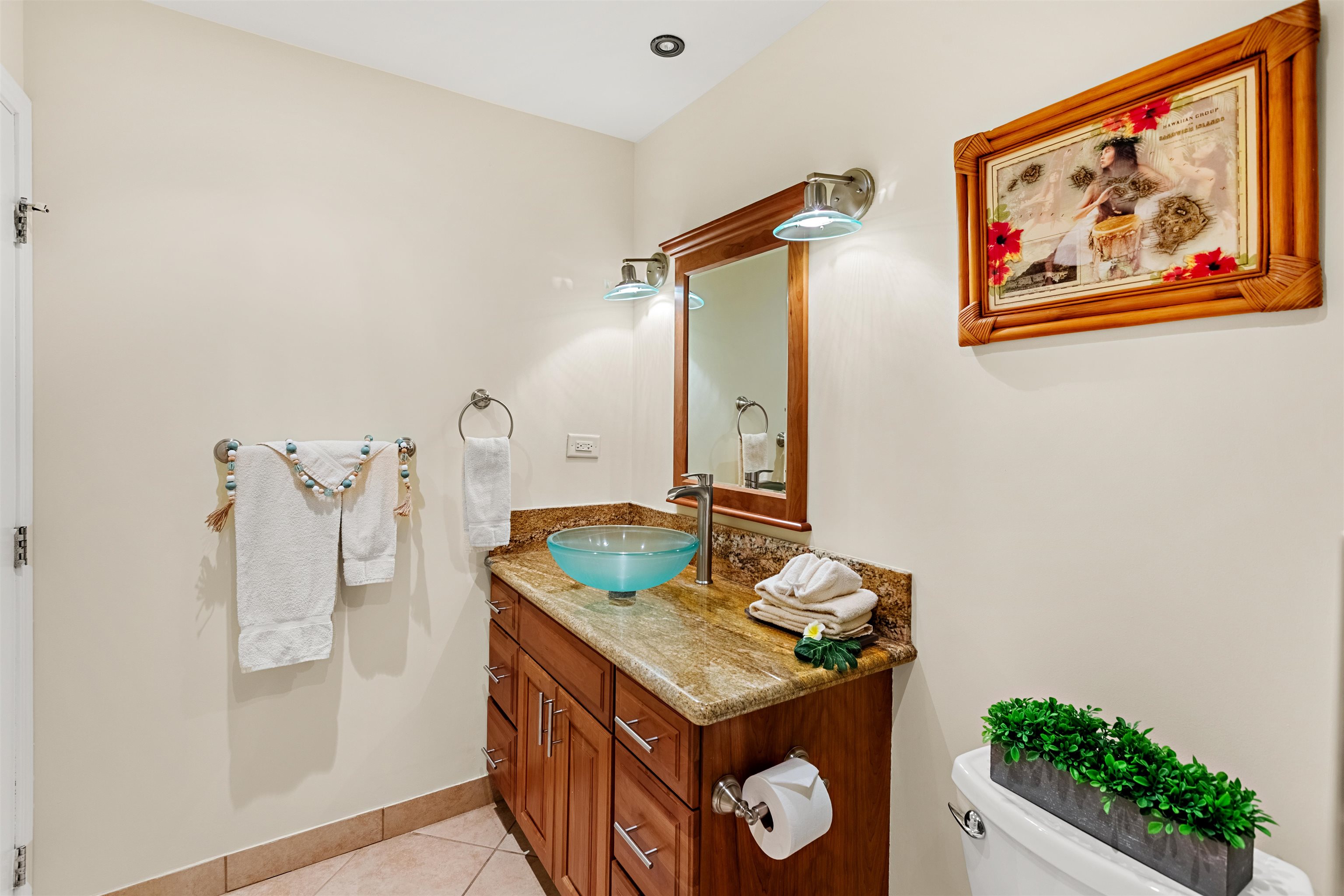 475 Front Street, Unit 635 Lahaina, HI 96761 - Photo 17 of 23 a bathroom with a granite countertop sink a mirror and shower