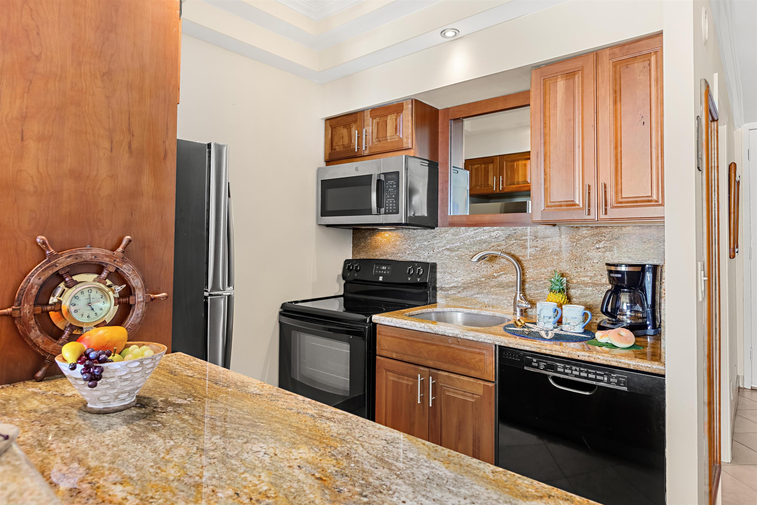 475 Front Street, Unit 635 Lahaina, HI 96761 - Photo 9 of 23 a kitchen with stainless steel appliances granite countertop a stove sink and cabinets