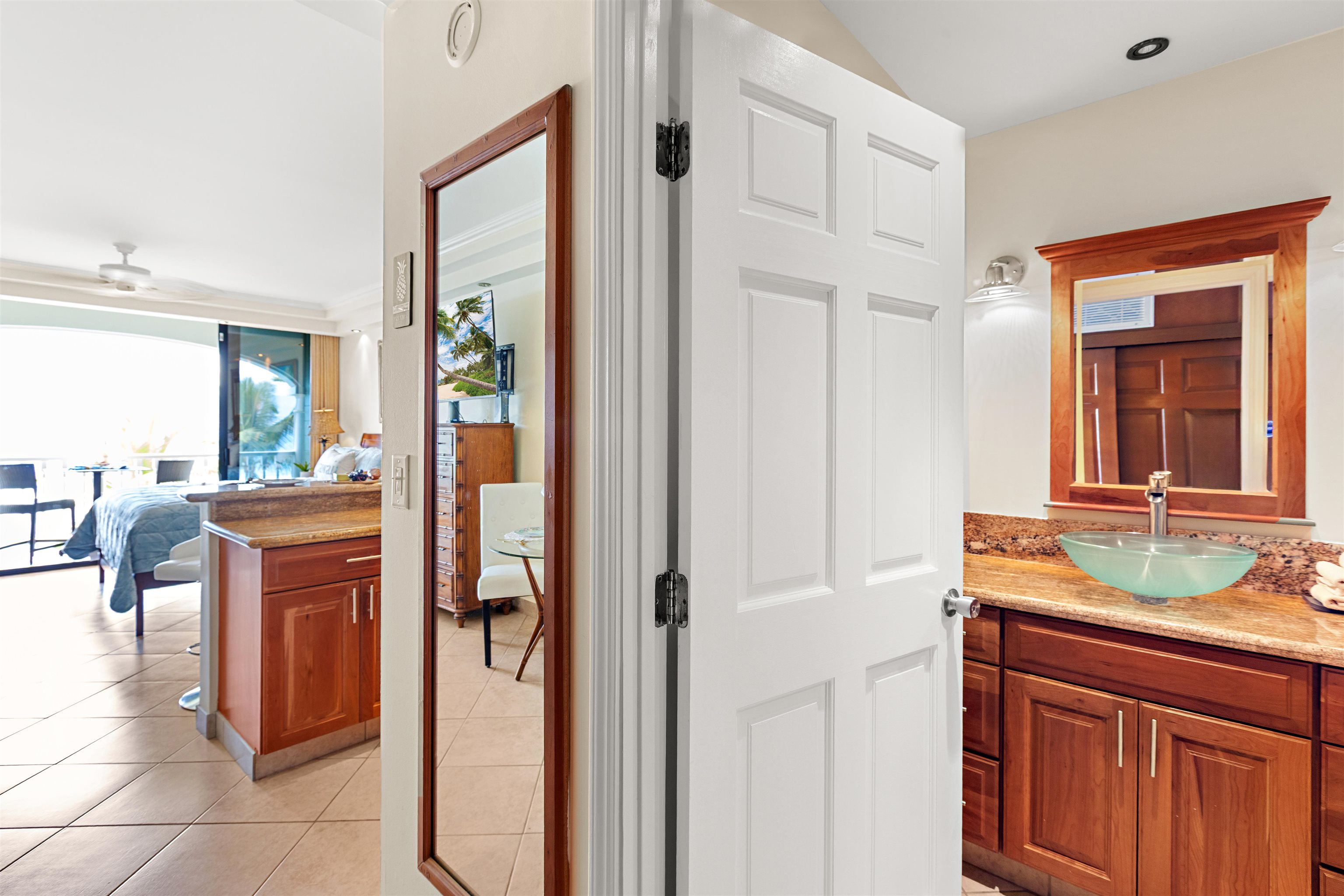 475 Front Street, Unit 635 Lahaina, HI 96761 - Photo 10 of 23 a bathroom with a granite countertop sink and a mirror