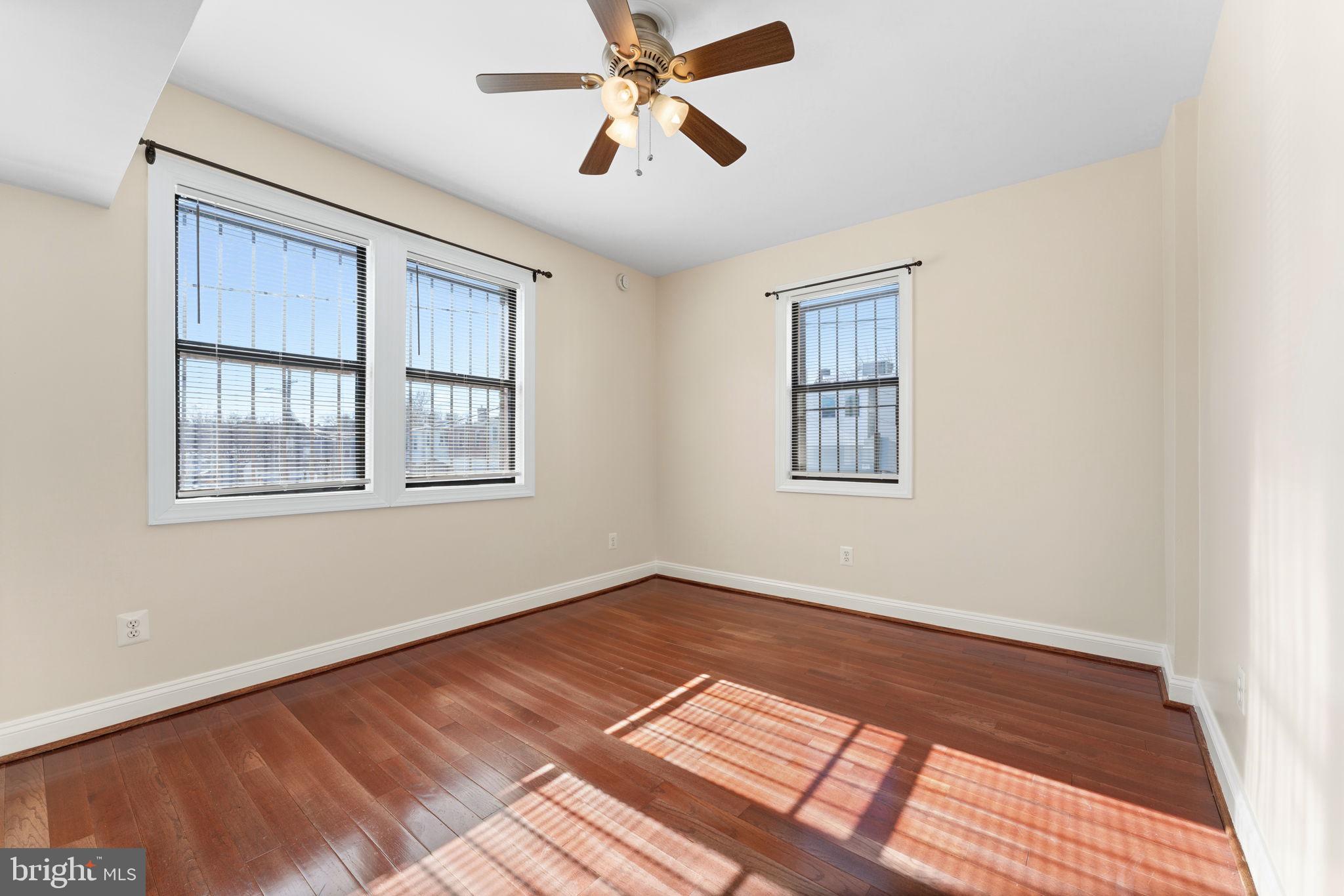 315 Evarts Street Northeast, Unit T6 Washington, DC 20002 - Photo 6 of 19 a view of an empty room with a window and wooden floor