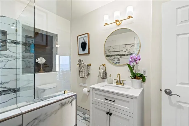 a bathroom with a sink mirror and vanity