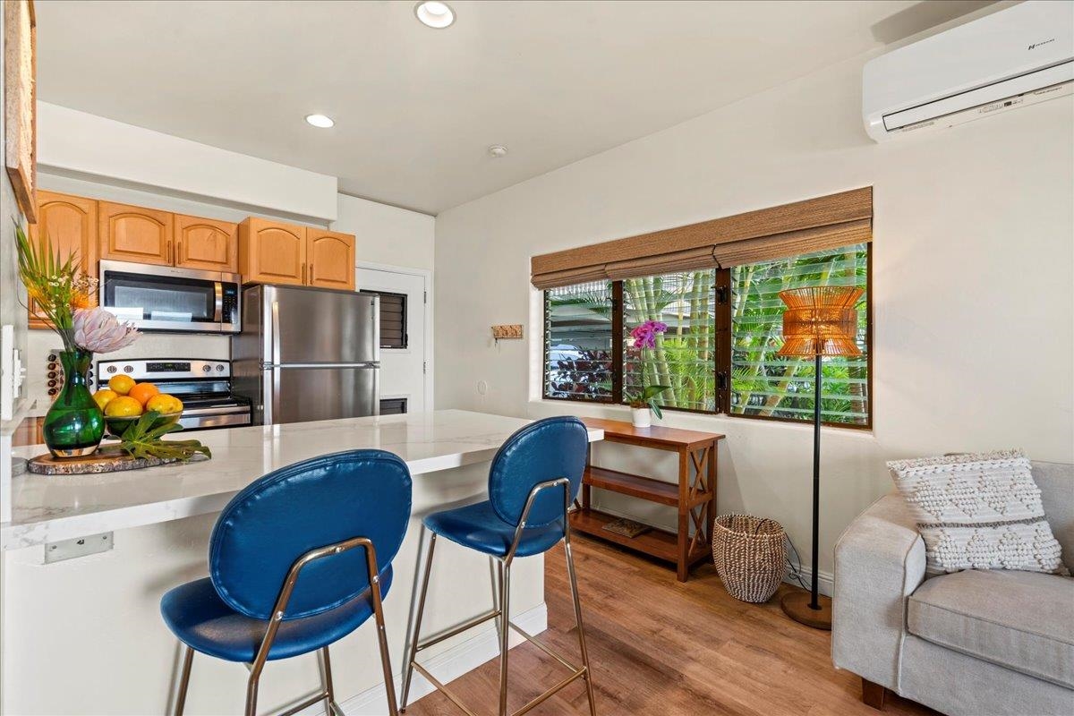 4435 Lower Honoapiilani Road, Unit 103 Lahaina, HI 96761 - Photo 22 of 34 a living room with furniture and a large window