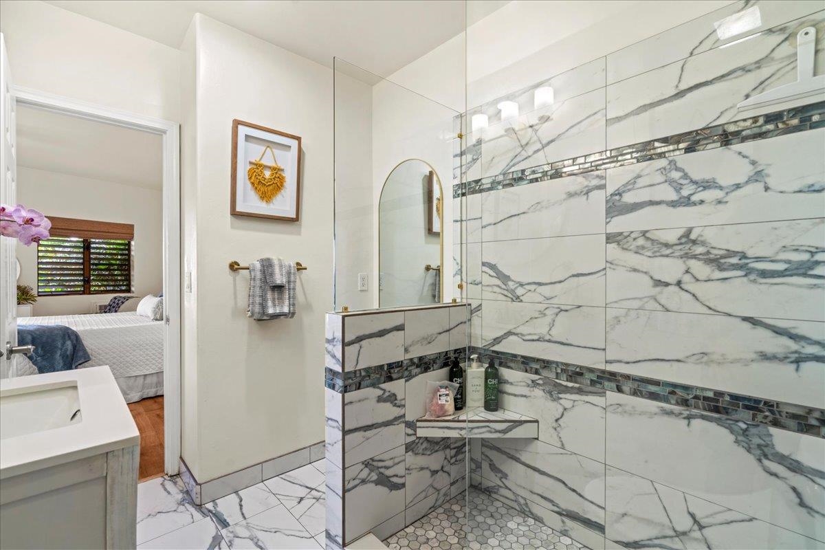 4435 Lower Honoapiilani Road, Unit 103 Lahaina, HI 96761 - Photo 23 of 34 a bathroom with a sink a toilet and shower