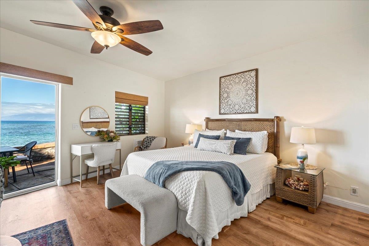 4435 Lower Honoapiilani Road, Unit 103 Lahaina, HI 96761 - Photo 24 of 34 a bedroom with a bed and wooden floor