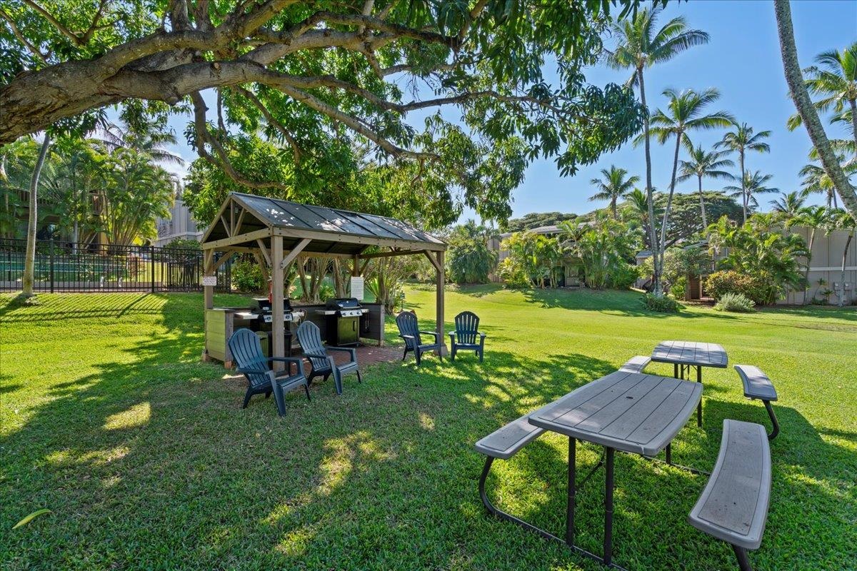 4435 Lower Honoapiilani Road, Unit 103 Lahaina, HI 96761 - Photo 34 of 34 a view of a table and chairs in patio with a yard