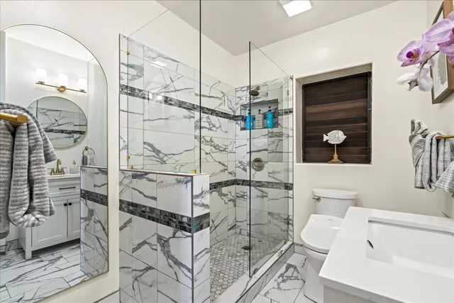 a bathroom with a sink toilet and shower