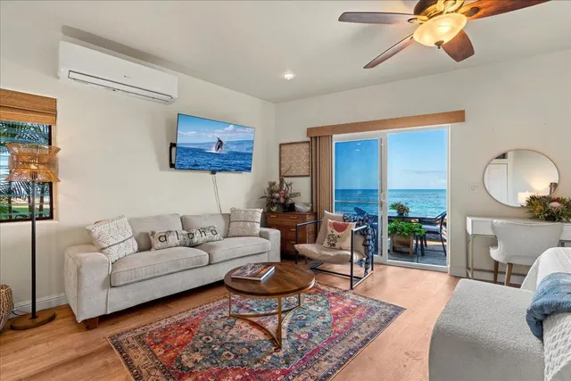 a living room with furniture a rug and a chandelier