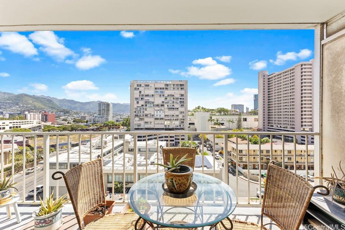 419 Atkinson Drive, Unit 902 Honolulu, HI 96814 - Photo 1 of 21 a view of a balcony with dining table and chairs