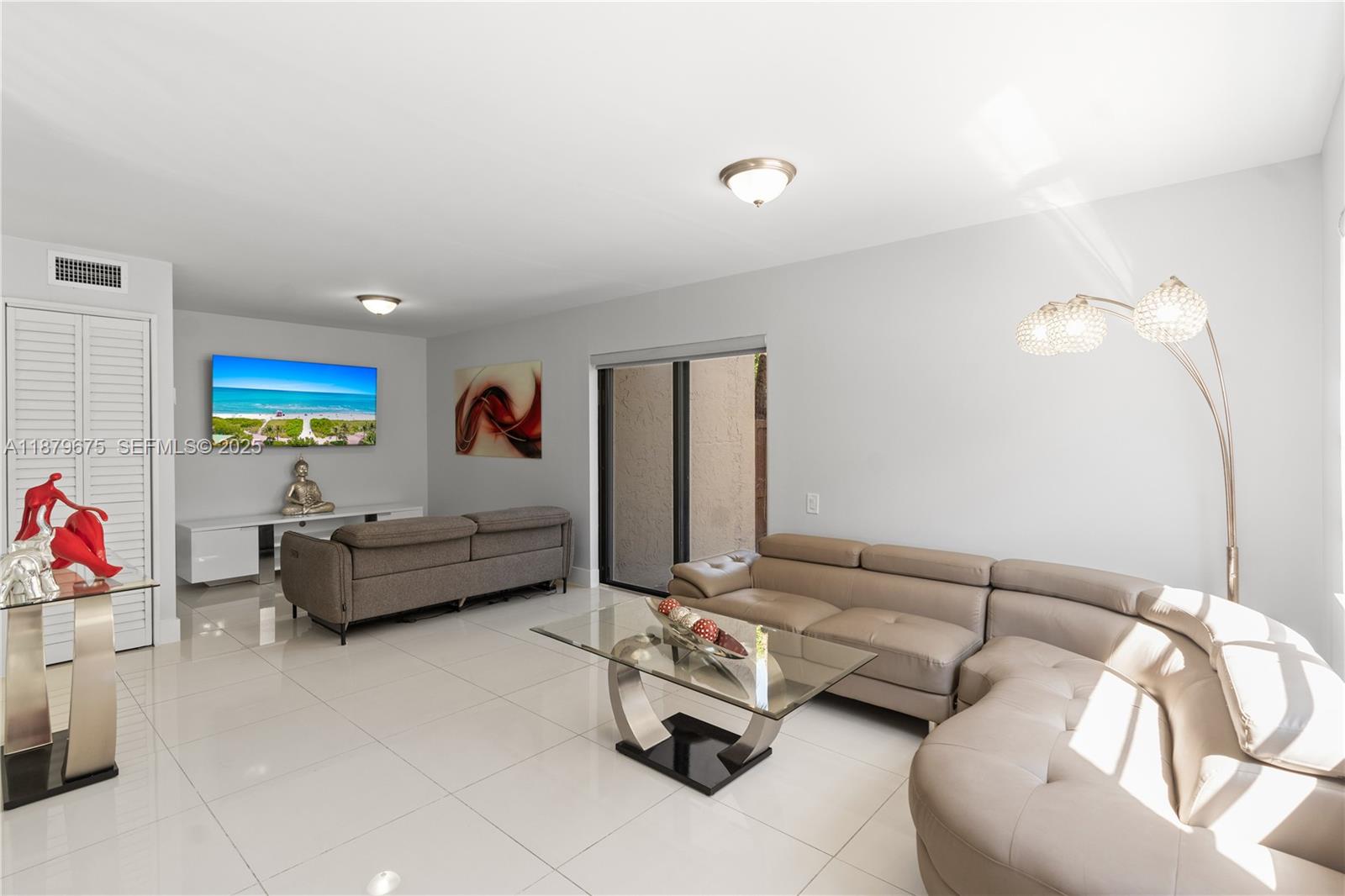 6621 Southwest 116th Place, Unit B2 Miami, FL 33173 - Photo 12 of 36 a living room with furniture and a couch