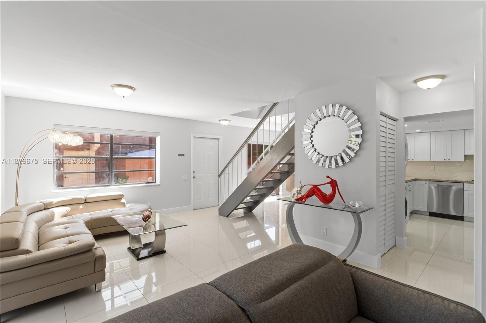 6621 Southwest 116th Place, Unit B2 Miami, FL 33173 - Photo 14 of 36 a living room with furniture and stairs