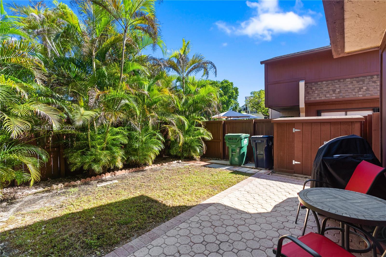 6621 Southwest 116th Place, Unit B2 Miami, FL 33173 - Photo 17 of 36 a view of a chair and table in the backyard of the house