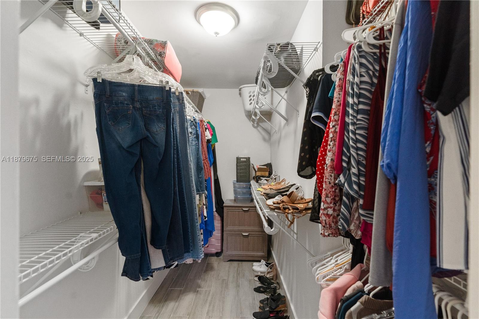 6621 Southwest 116th Place, Unit B2 Miami, FL 33173 - Photo 24 of 36 a view of walk in closet with clothes