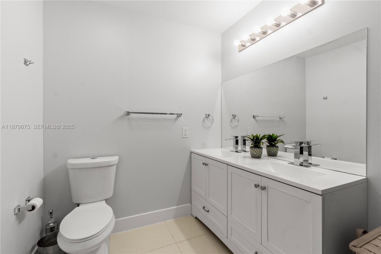 6621 Southwest 116th Place, Unit B2 Miami, FL 33173 - Photo 25 of 36 a bathroom with a toilet sink and mirror