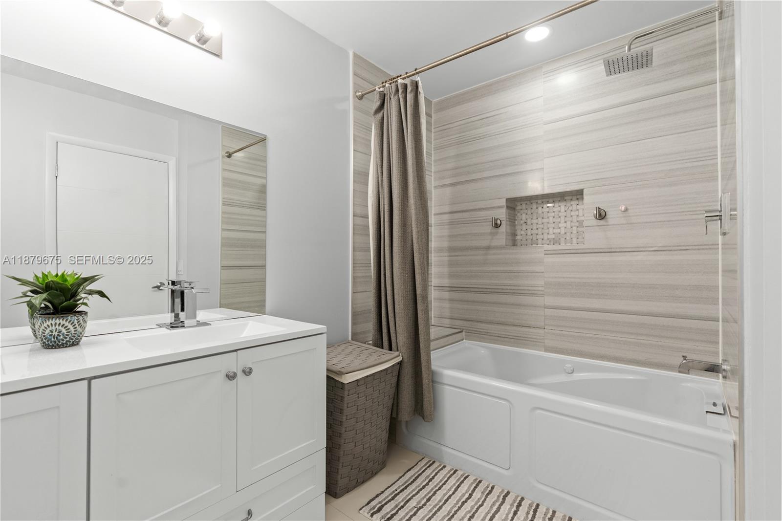 6621 Southwest 116th Place, Unit B2 Miami, FL 33173 - Photo 26 of 36 a bathroom with a bathtub a sink and a shower