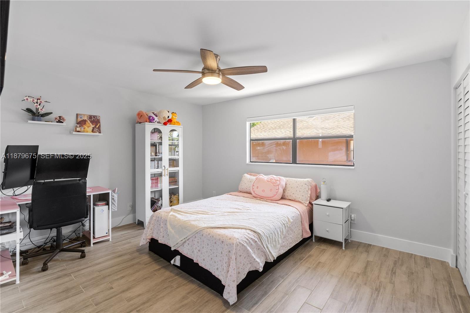 6621 Southwest 116th Place, Unit B2 Miami, FL 33173 - Photo 28 of 36 a bedroom with a bed and a window