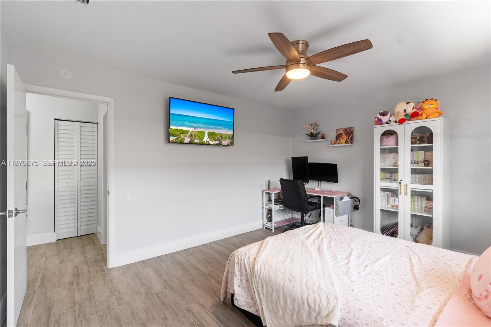 6621 Southwest 116th Place, Unit B2 Miami, FL 33173 - Photo 29 of 36 a bedroom with a bed and a flat screen tv