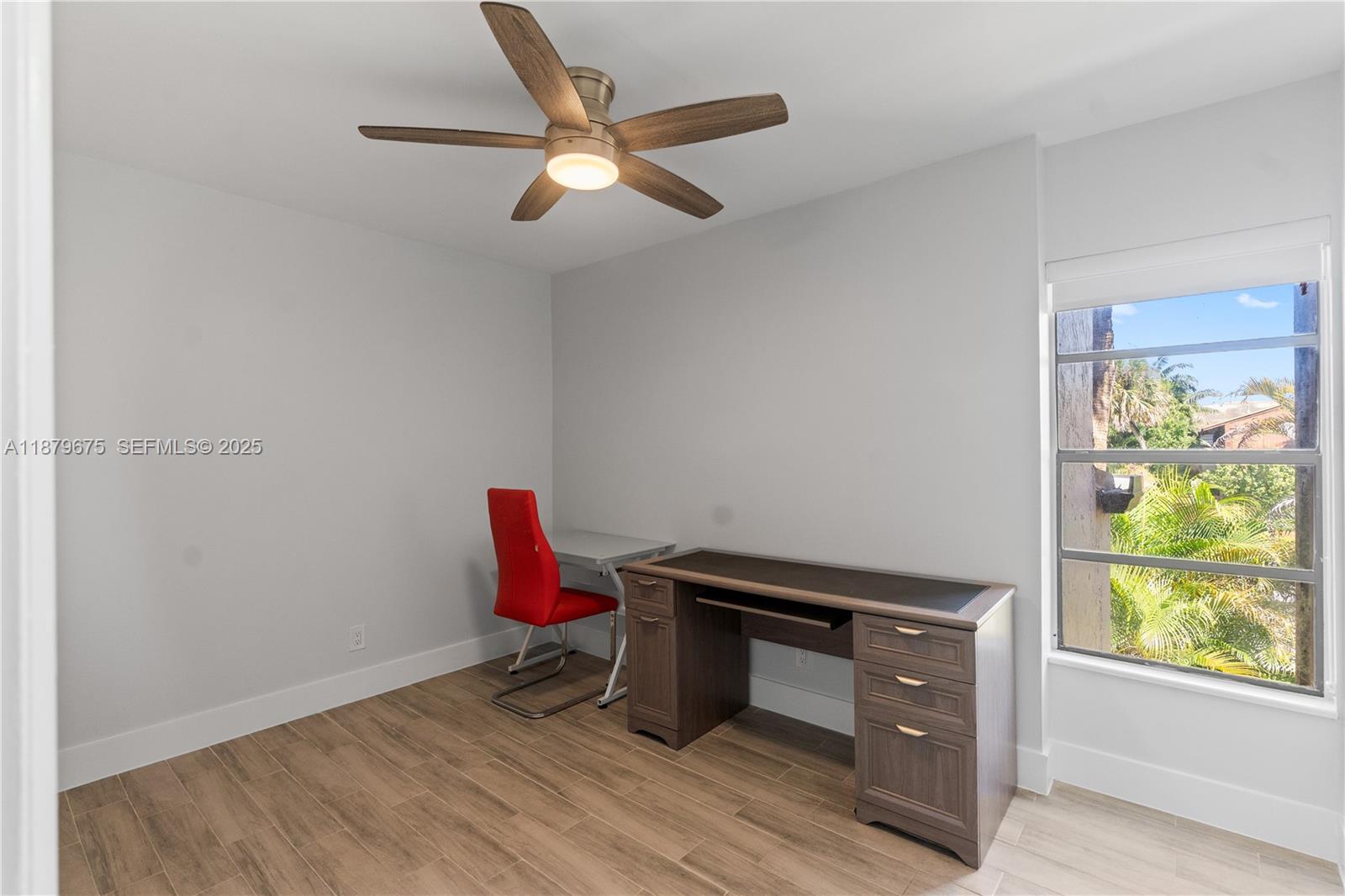 6621 Southwest 116th Place, Unit B2 Miami, FL 33173 - Photo 31 of 36 a room with a wooden floor and a window