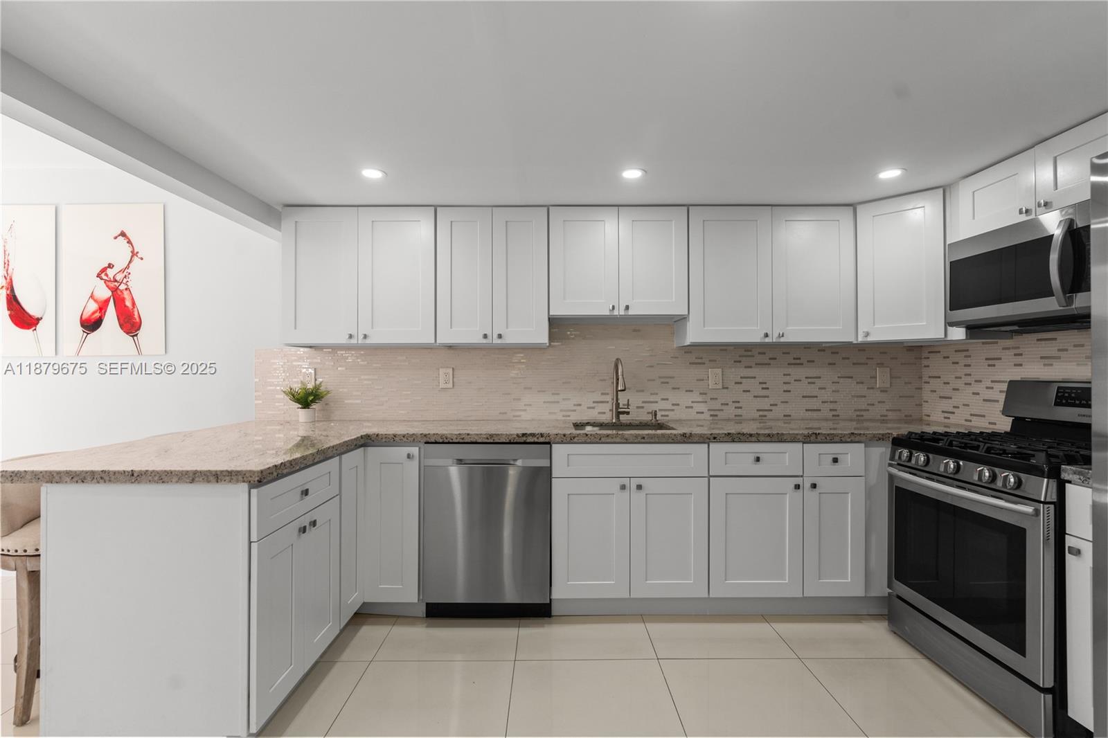 6621 Southwest 116th Place, Unit B2 Miami, FL 33173 - Photo 7 of 36 a kitchen with granite countertop a sink and cabinets
