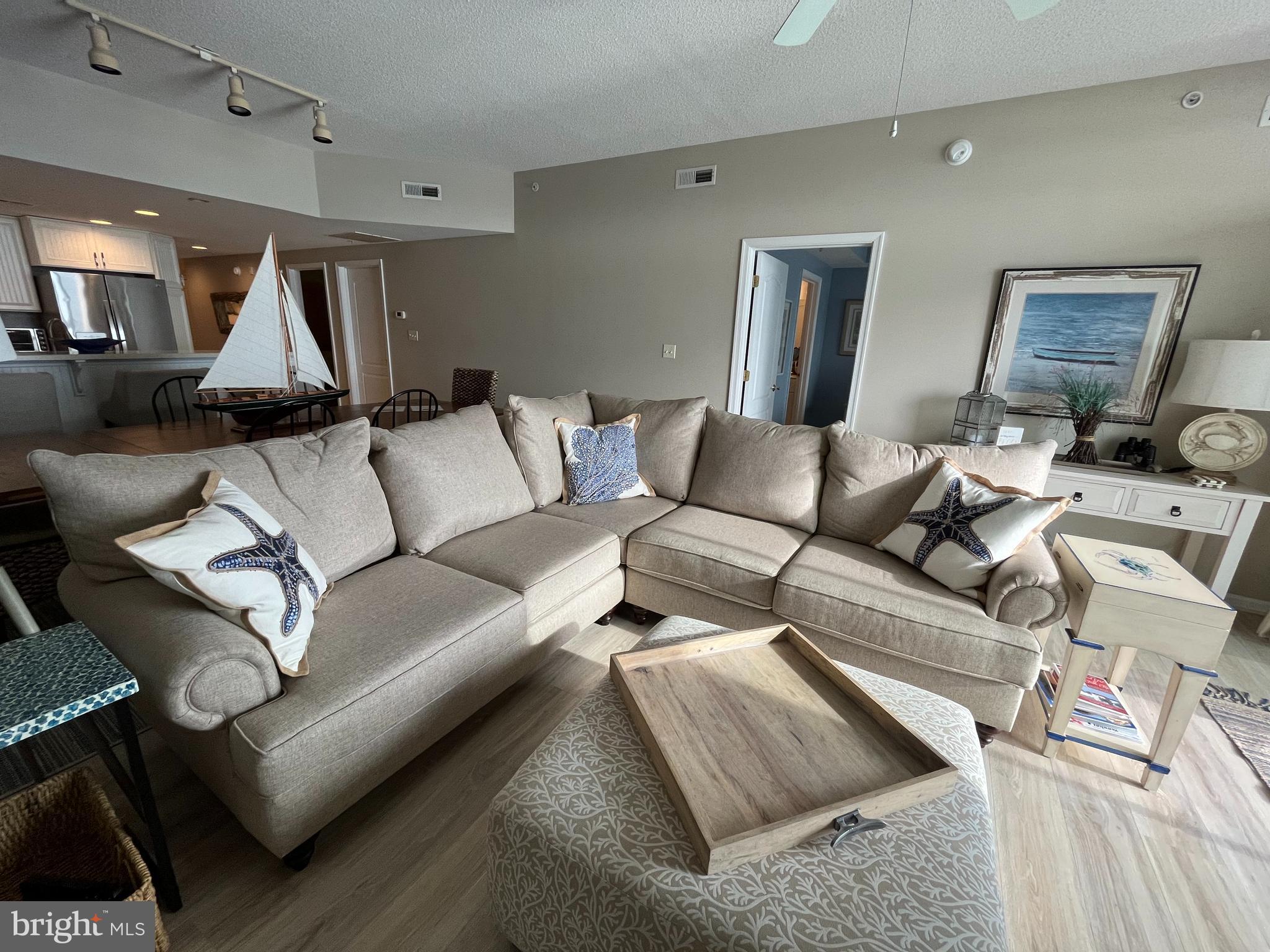 103 Williams Street, Unit 213 Crisfield, MD 21817 - Photo 16 of 25 a living room with furniture and a wooden floor