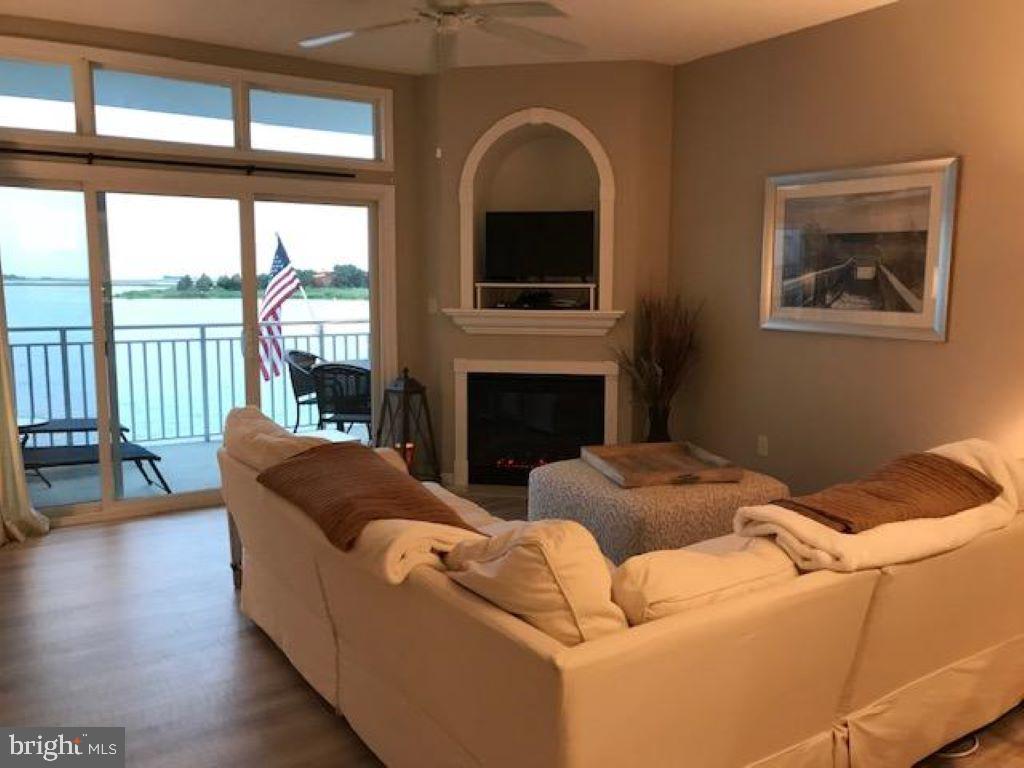 103 Williams Street, Unit 213 Crisfield, MD 21817 - Photo 17 of 25 a living room with furniture and a fireplace