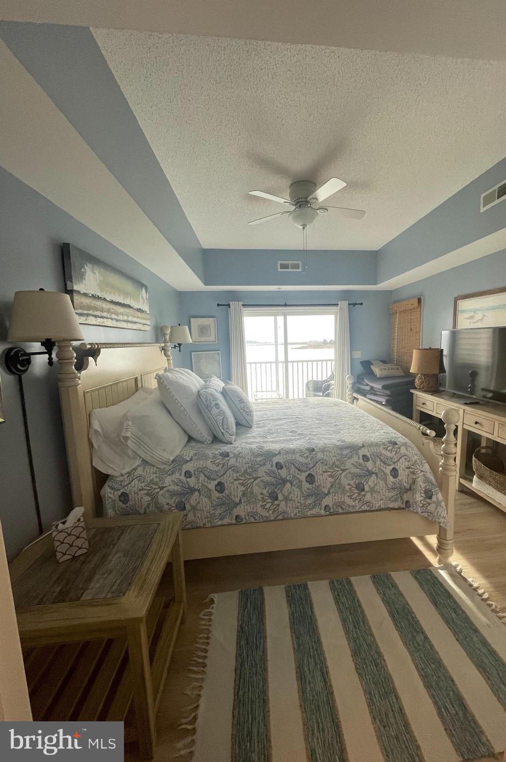 103 Williams Street, Unit 213 Crisfield, MD 21817 - Photo 18 of 25 a bedroom with a bed and large mirror on the dresser