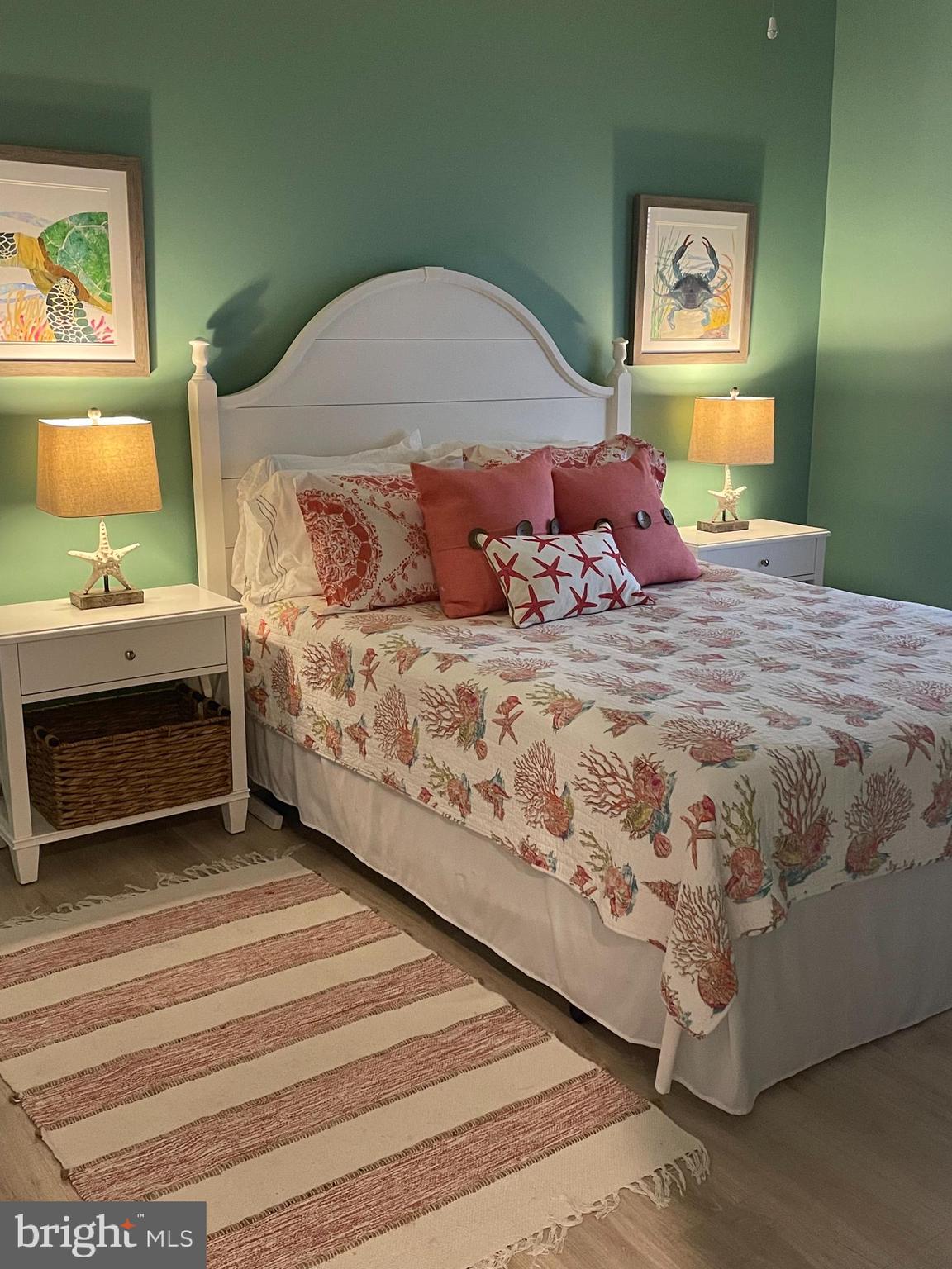 103 Williams Street, Unit 213 Crisfield, MD 21817 - Photo 23 of 25 a bedroom with a bed and a painting on the wall