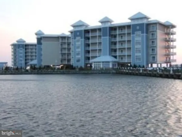 a front view of a building with a yard
