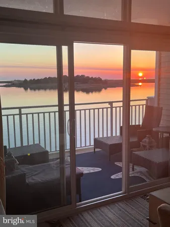 a kitchen with a sink a stove top oven and wooden floor