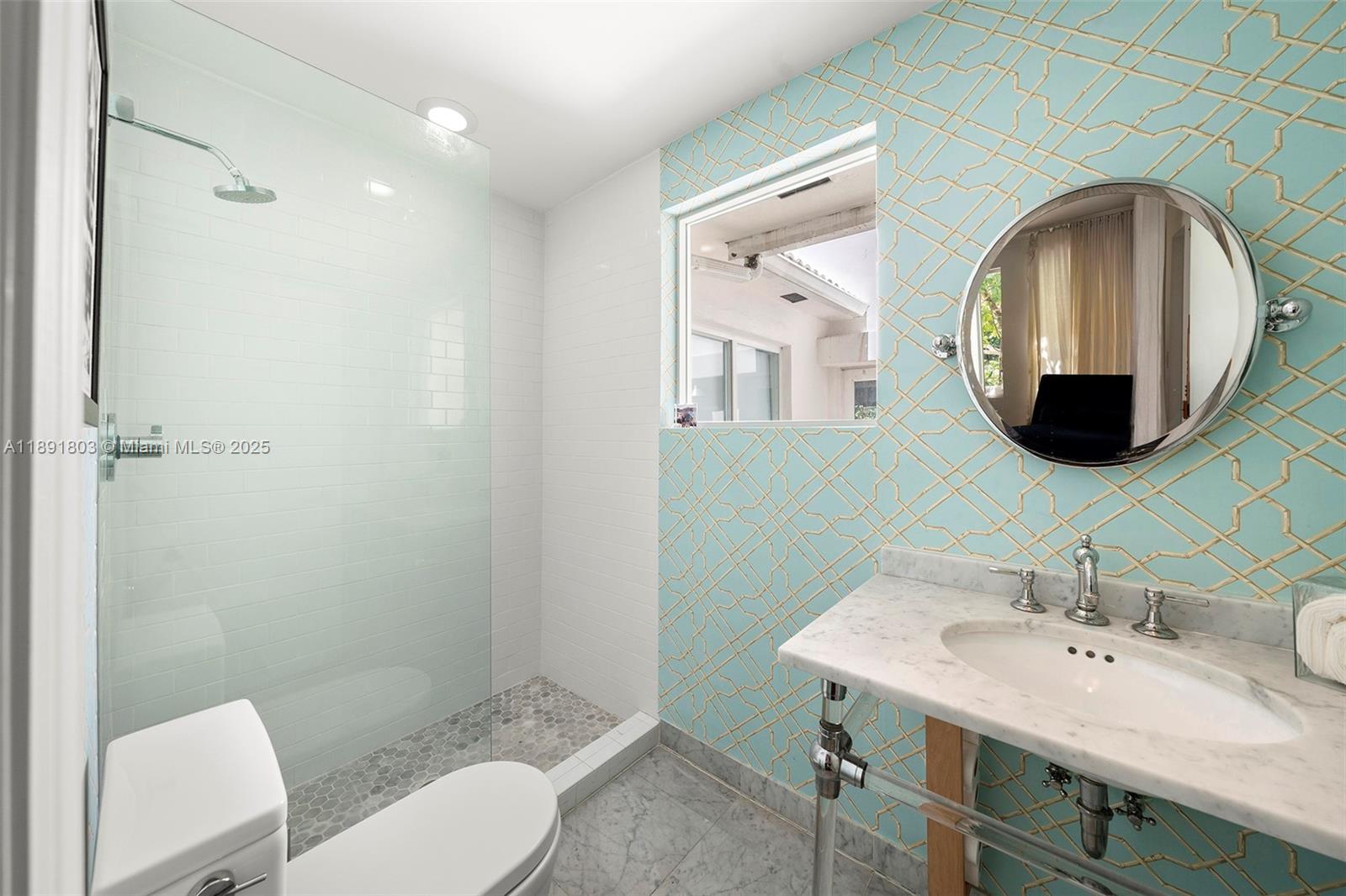 2701 North Bay Road Miami Beach, FL 33140 - Photo 15 of 38 a bathroom with a toilet sink and mirror